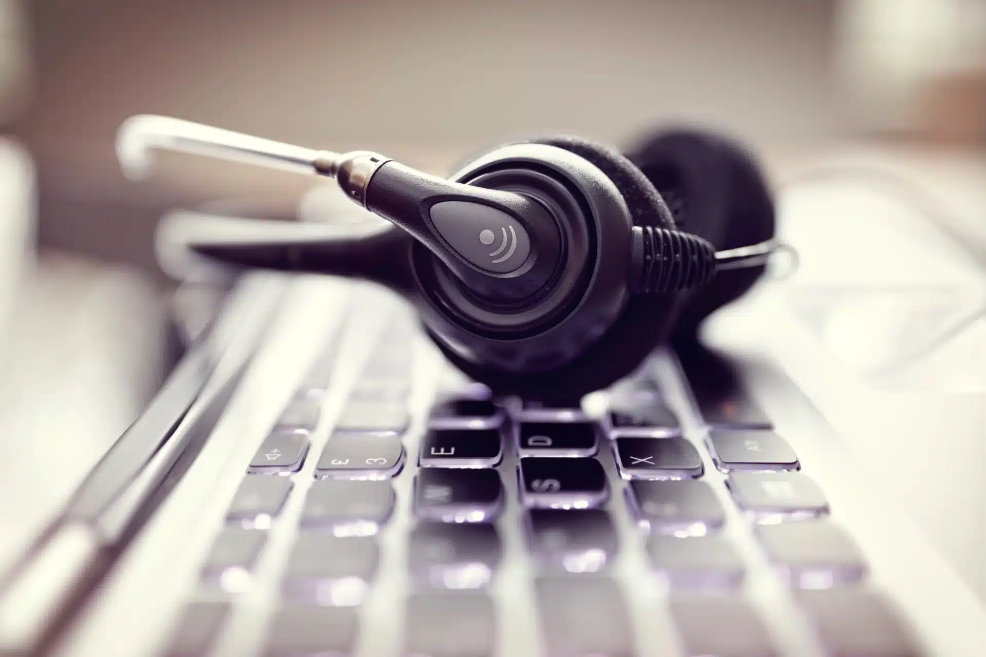 Headset resting on a keyboard, symbolizing B2C and B2B telemarketing communication strategies for customer engagement.