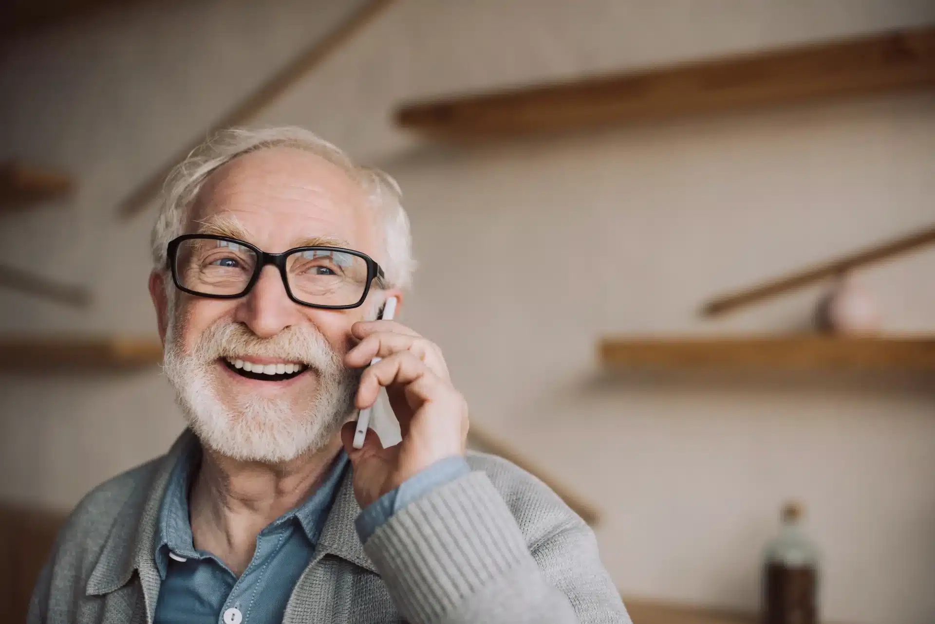 Smiling older man on phone, representing voter outreach and engagement strategies for political campaigns.